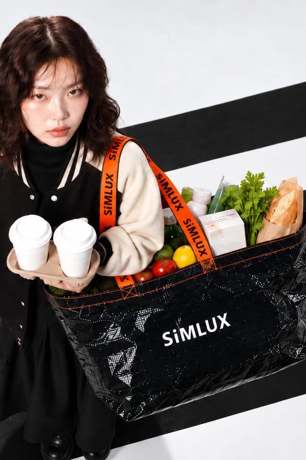 Model on a crosswalk holding coffees, Cargo Bag full of groceries