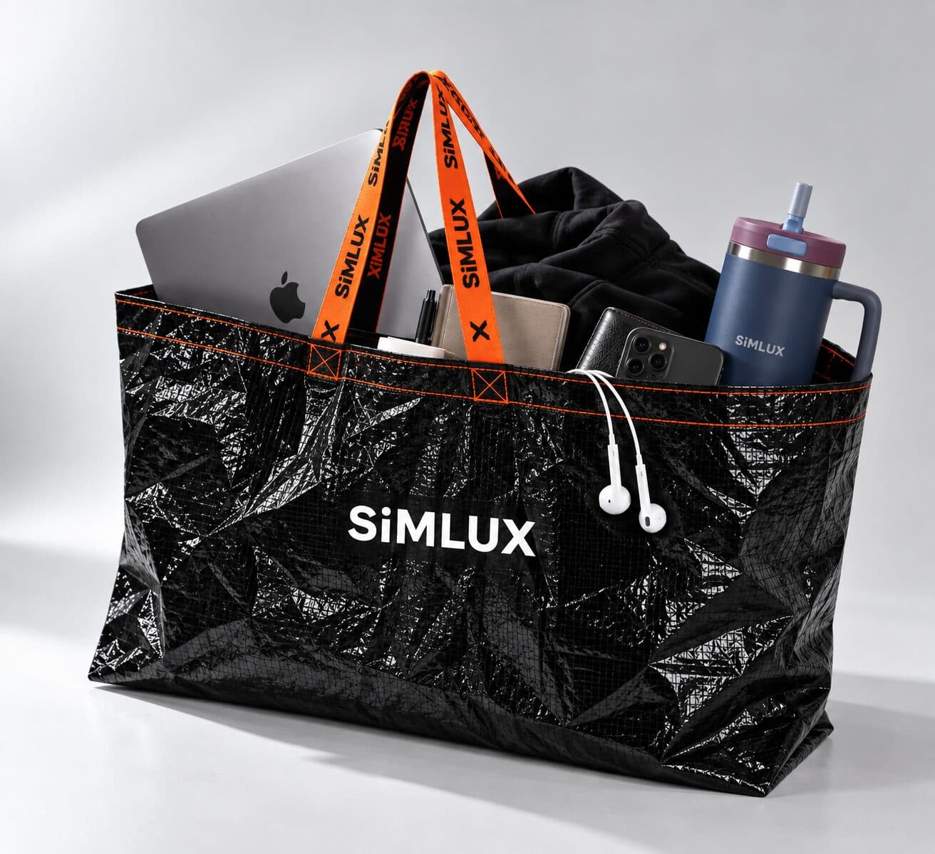 SiMLUX Cargo Bag packed with a laptop, tumbler and earphones