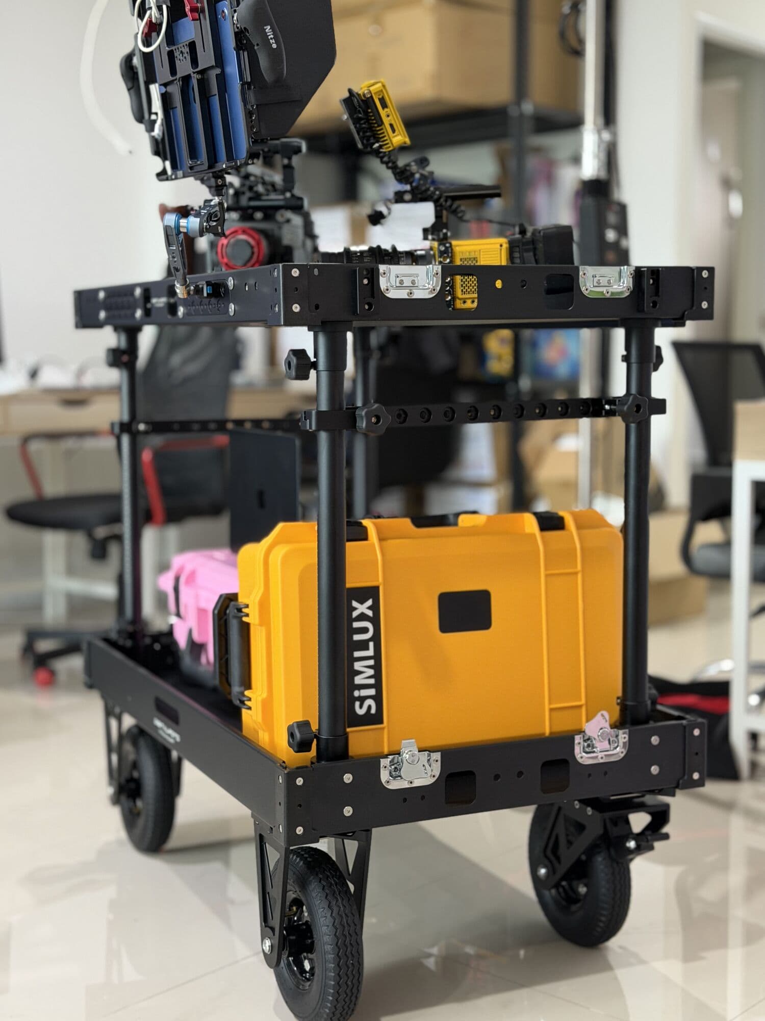 Yellow case strapped to a camera cart on set